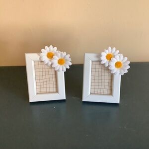 Set of 2…2x3 white frames embellished with two white daisy blooms